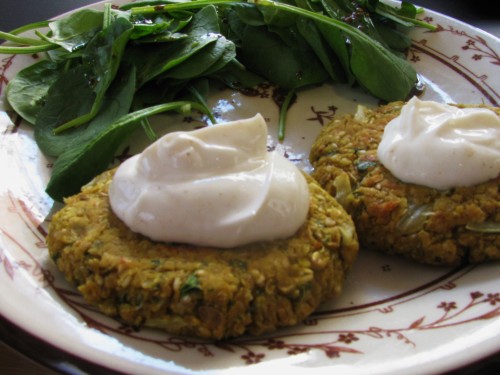 Spiced sesame-lentil patties served with Greek yogurt and a spinach salad with dijon vinaigrette